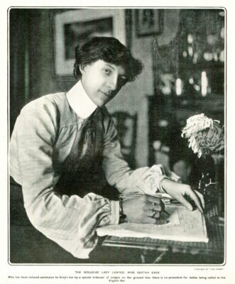 Black and white photograph of Bertha Cave writing at a desk