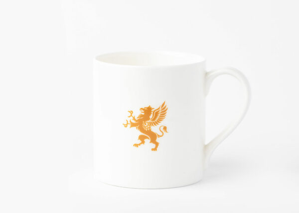 A white ceramic mug positioned against a plain white background featuring an elegant gold emblem of a griffin.