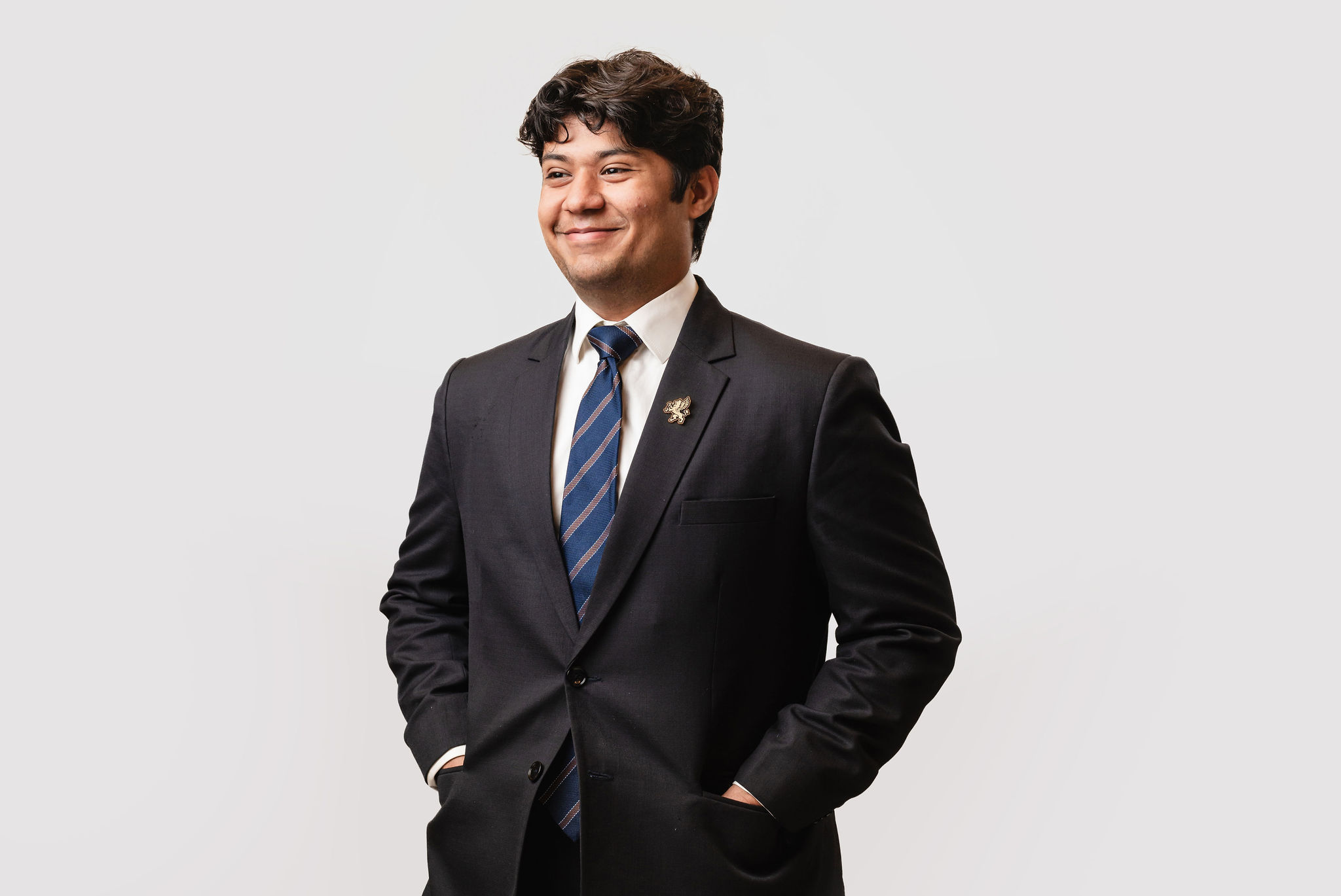 Model wearing suit and enamel lapel pin