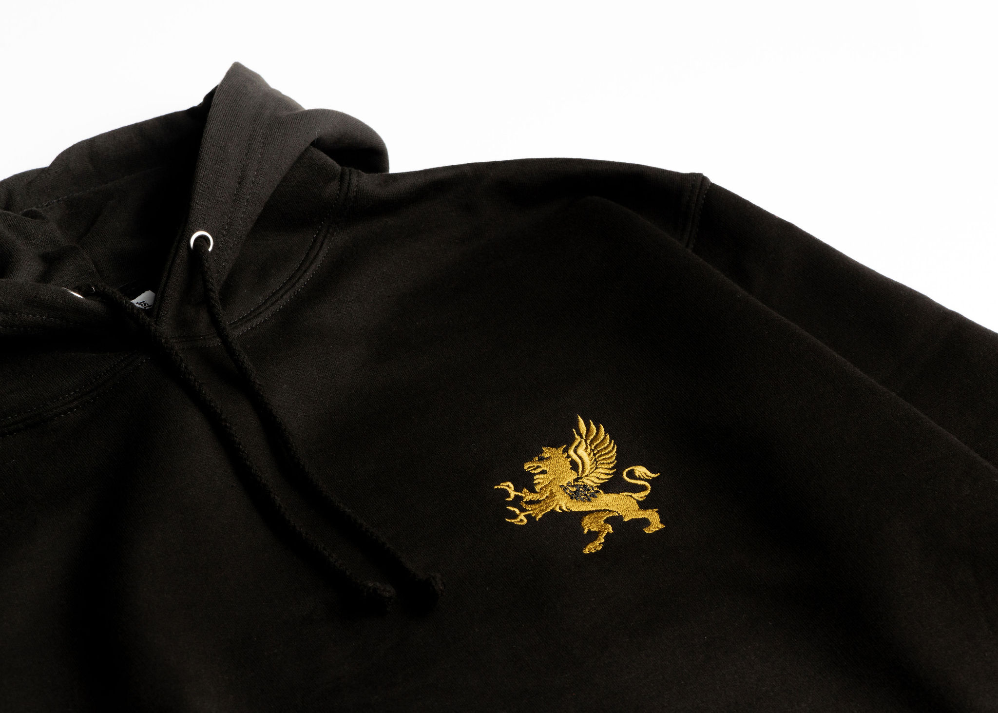 A black hoodie is displayed against a plain white background. The hoodie features a gold emblem of a griffin embroidered on the chest area