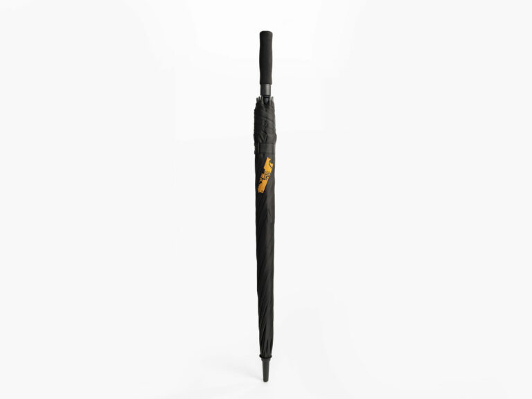 A sleek, black umbrella is displayed against a plain white background. The umbrella is closed and features a gold emblem of a griffin on the shaft. The handle is also black