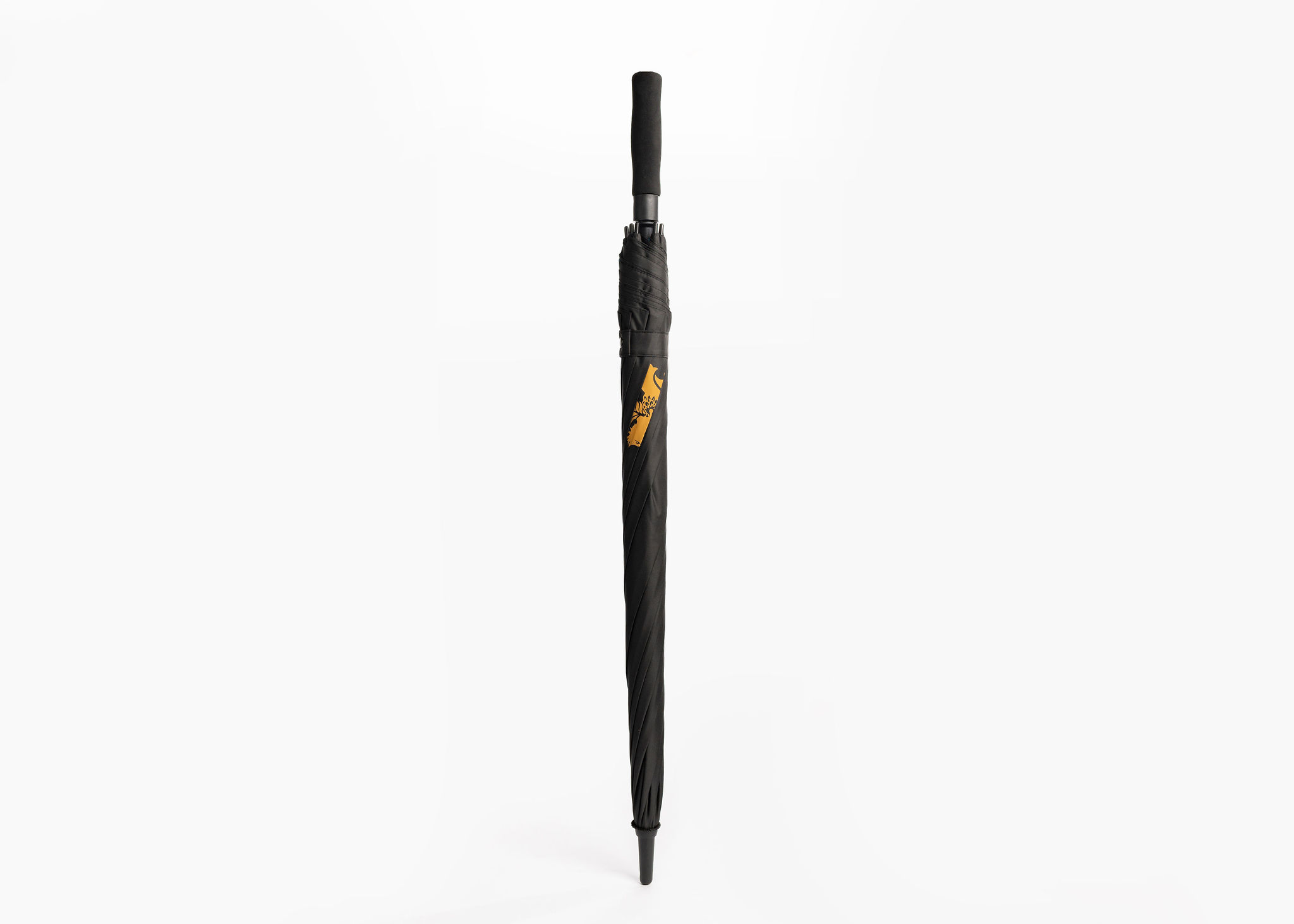 A sleek, black umbrella is displayed against a plain white background. The umbrella is closed and features a gold emblem of a griffin on the shaft. The handle is also black