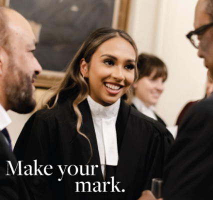 Woman smiling wearing barristers robes
